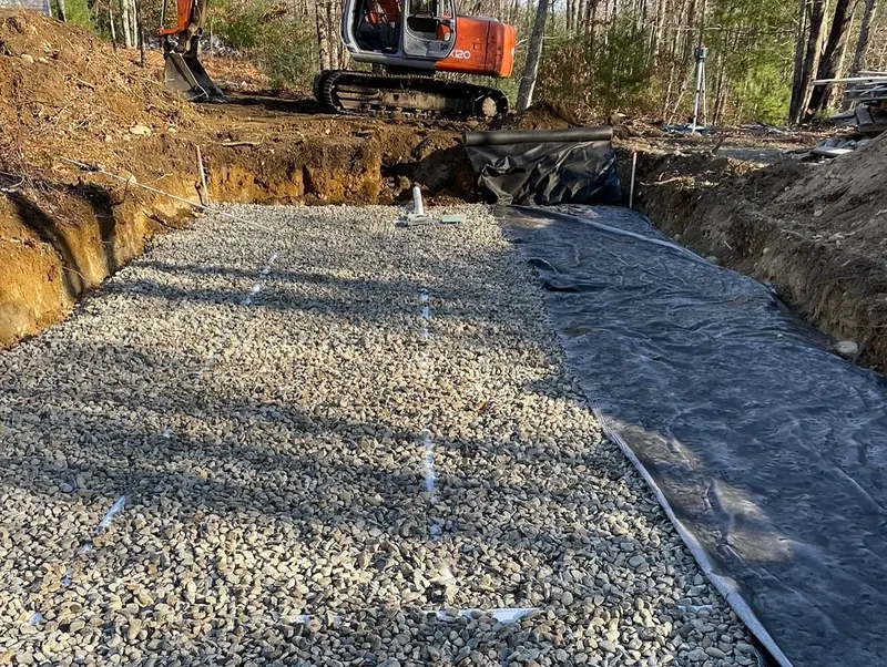 Crushed stone leach bed laid over filter fabric